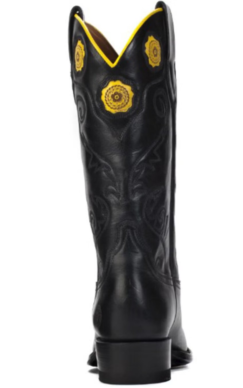 Ranch Road Boots tall leather Western cowboy boots displayed against a warm rustic background, showcasing craftsmanship and design detail